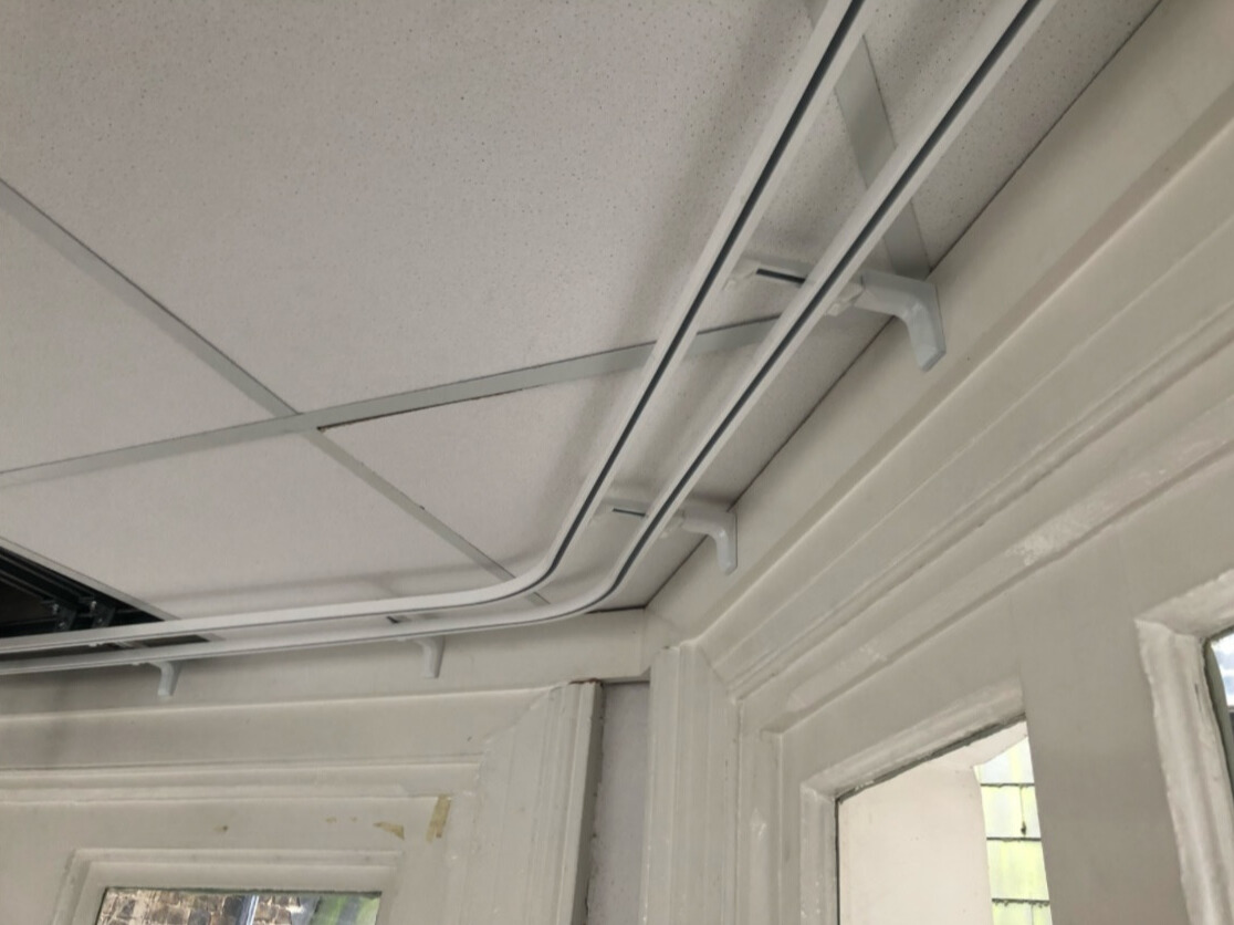 Installed curtain tracks with curtains hanging neatly